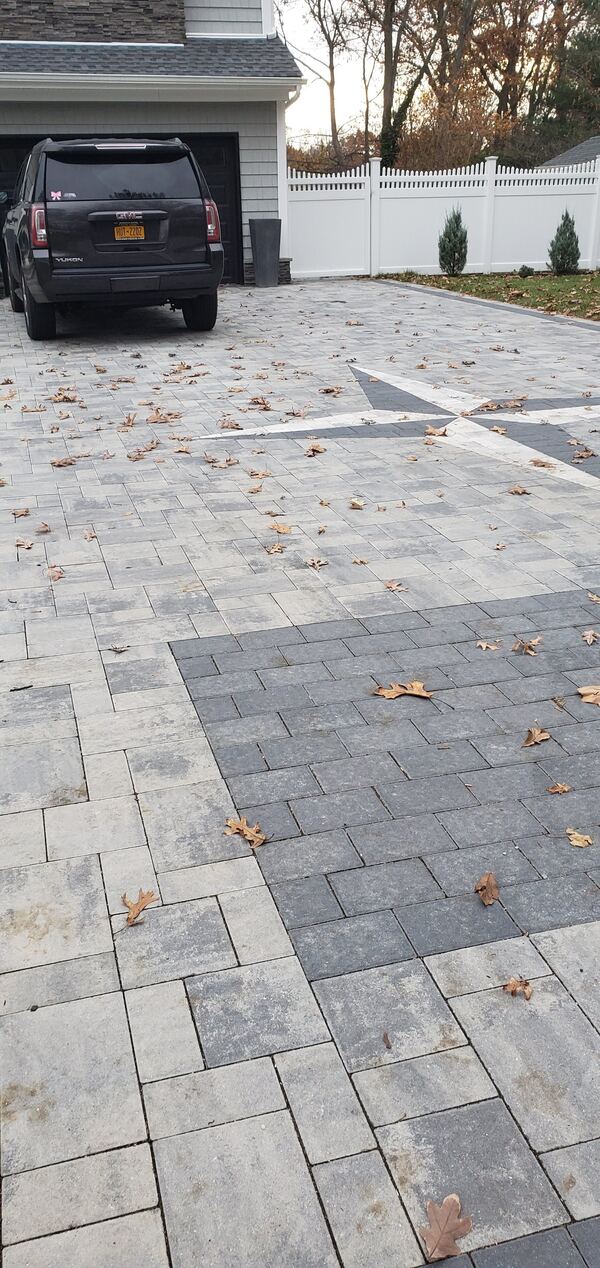 Completed paver driveway installation with contrasting border