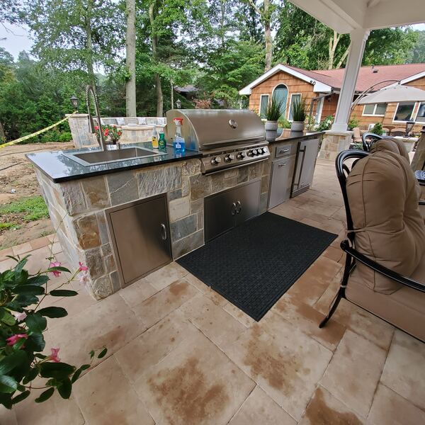 Custom outdoor kitchen with stone veneer and built-in grill