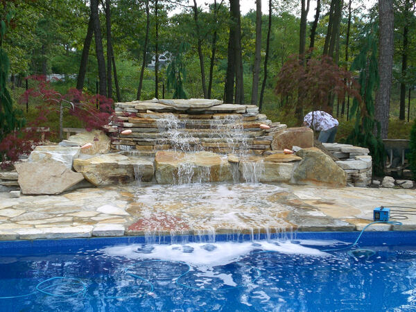 Freeform pool with custom paver decking