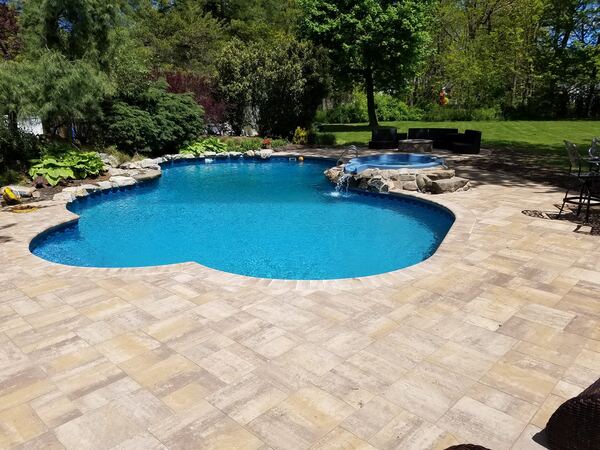 Pool surround with integrated spa and stone coping