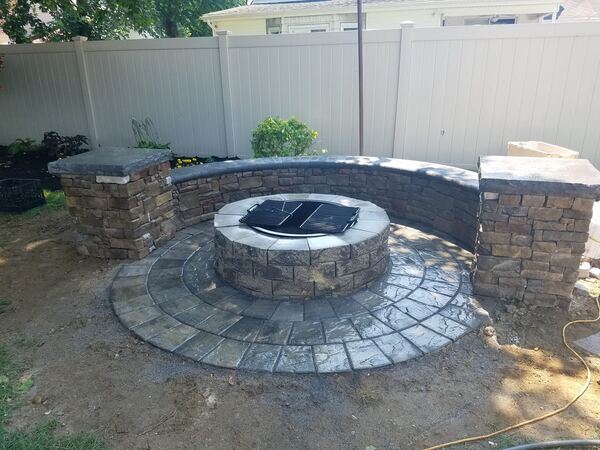 Stone veneer outdoor fireplace with mantel
