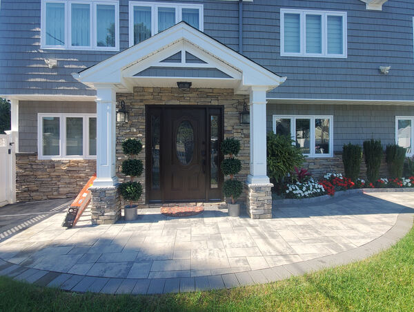 Grand paver walkway leading to arched entryway