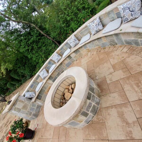 Paver walkway with inlaid design connecting patio areas